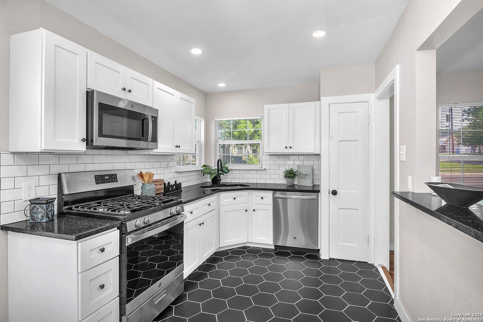 a kitchen with a sink stove and microwave