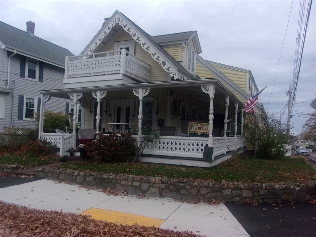 a view of a house with a small yard and outdoor seating