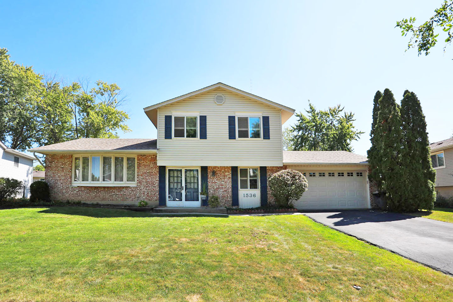 a front view of a house with a garden