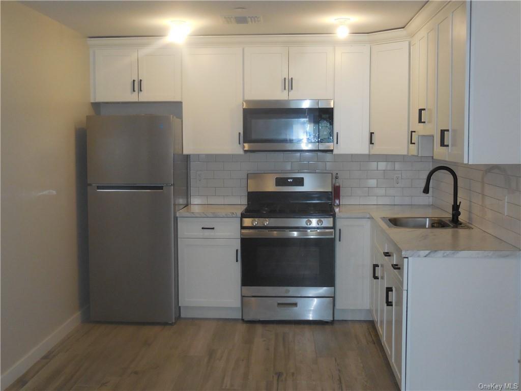 a kitchen with stainless steel appliances a refrigerator stove and sink