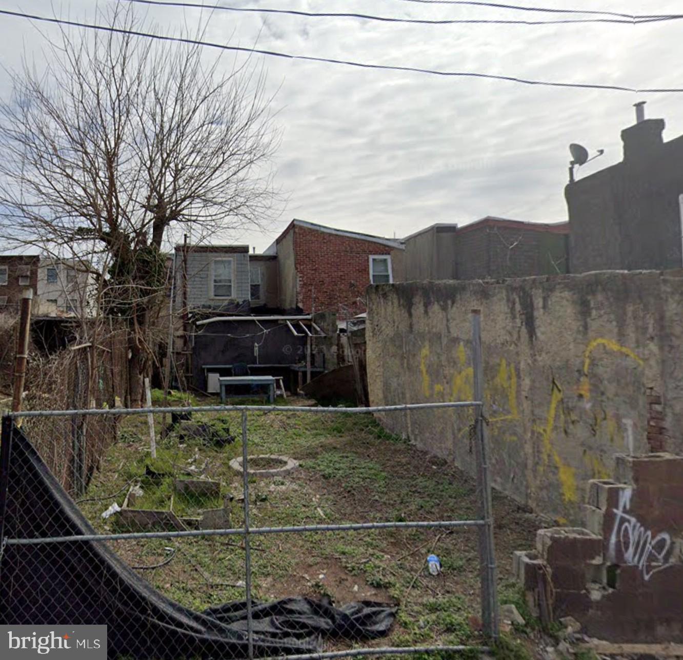 a view of a brick house with a small yard