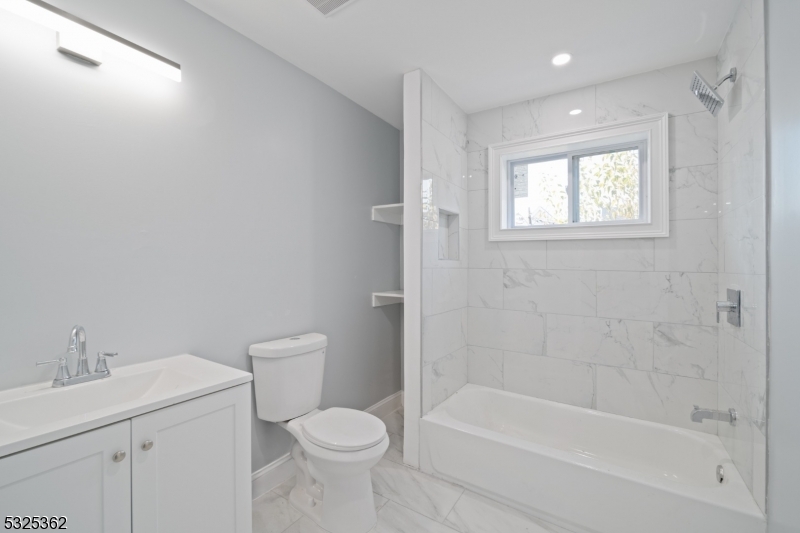 a bathroom with a bathtub toilet and sink