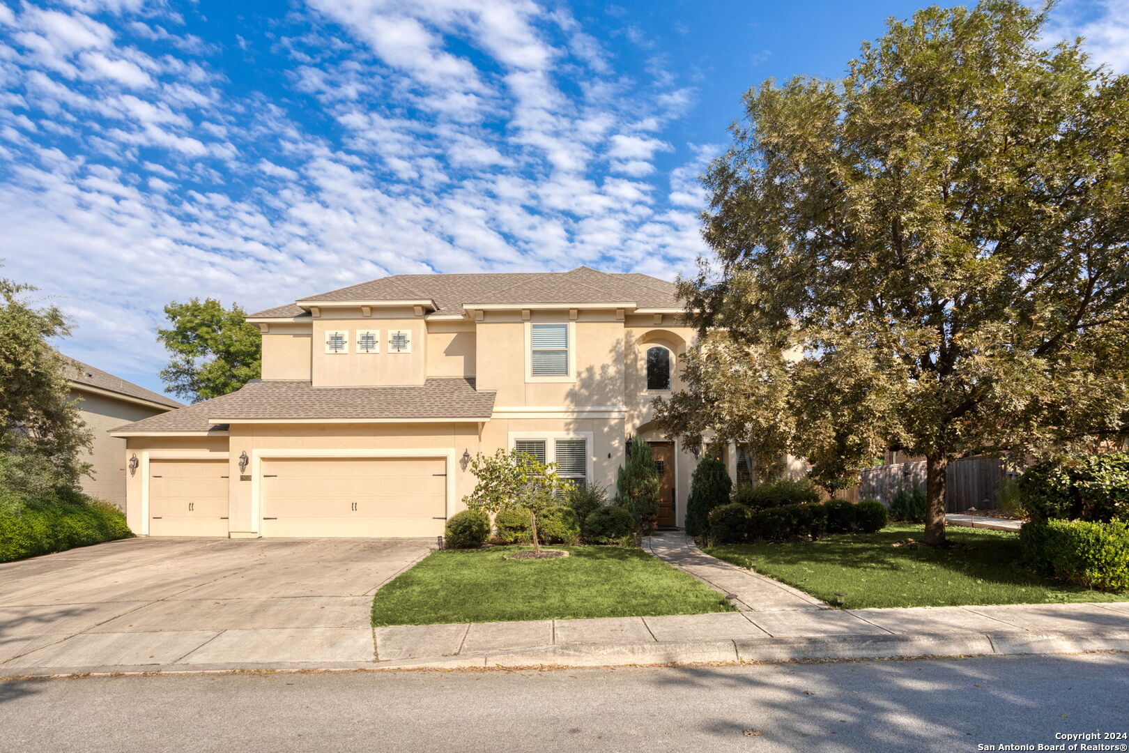 a front view of a house with a yard and a garage