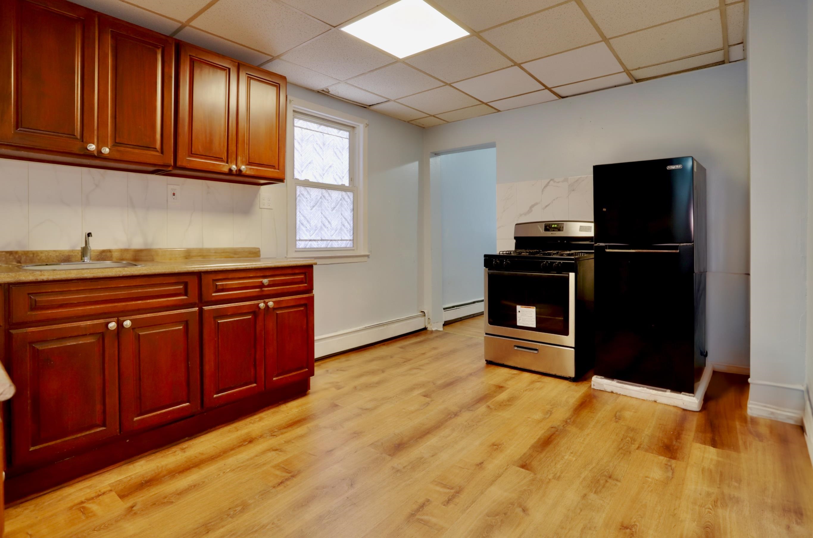 a kitchen with stainless steel appliances granite countertop a refrigerator and a stove top oven