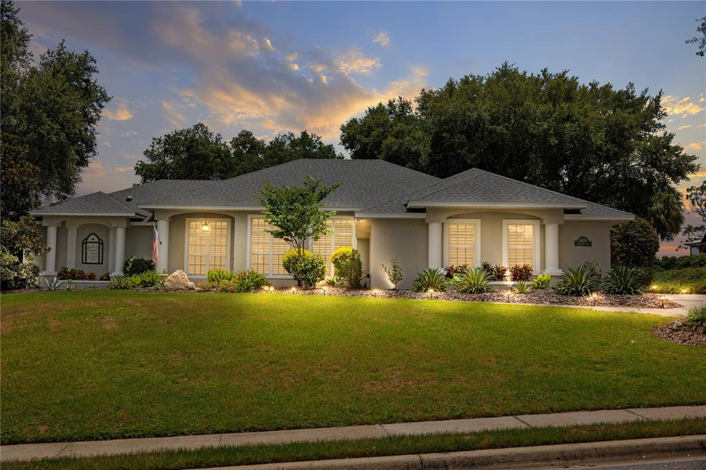 a front view of a house with swimming pool having outdoor seating