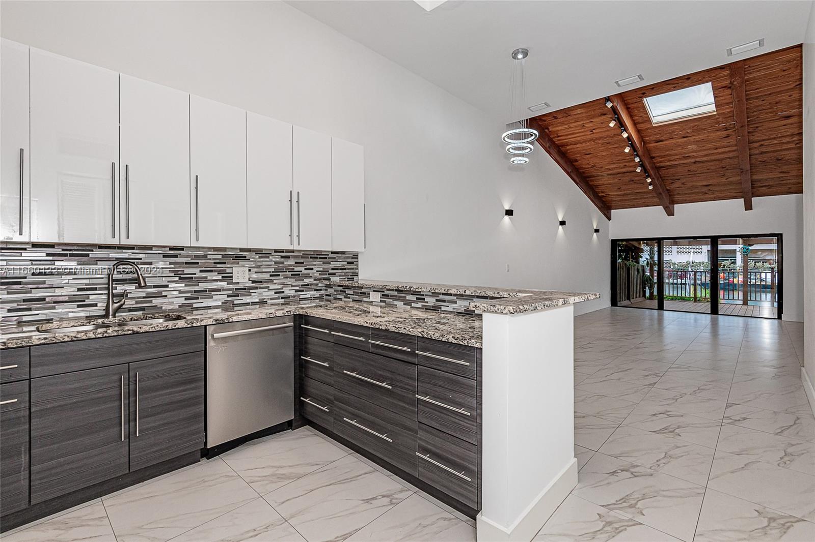 a kitchen with granite countertop a stove and cabinets