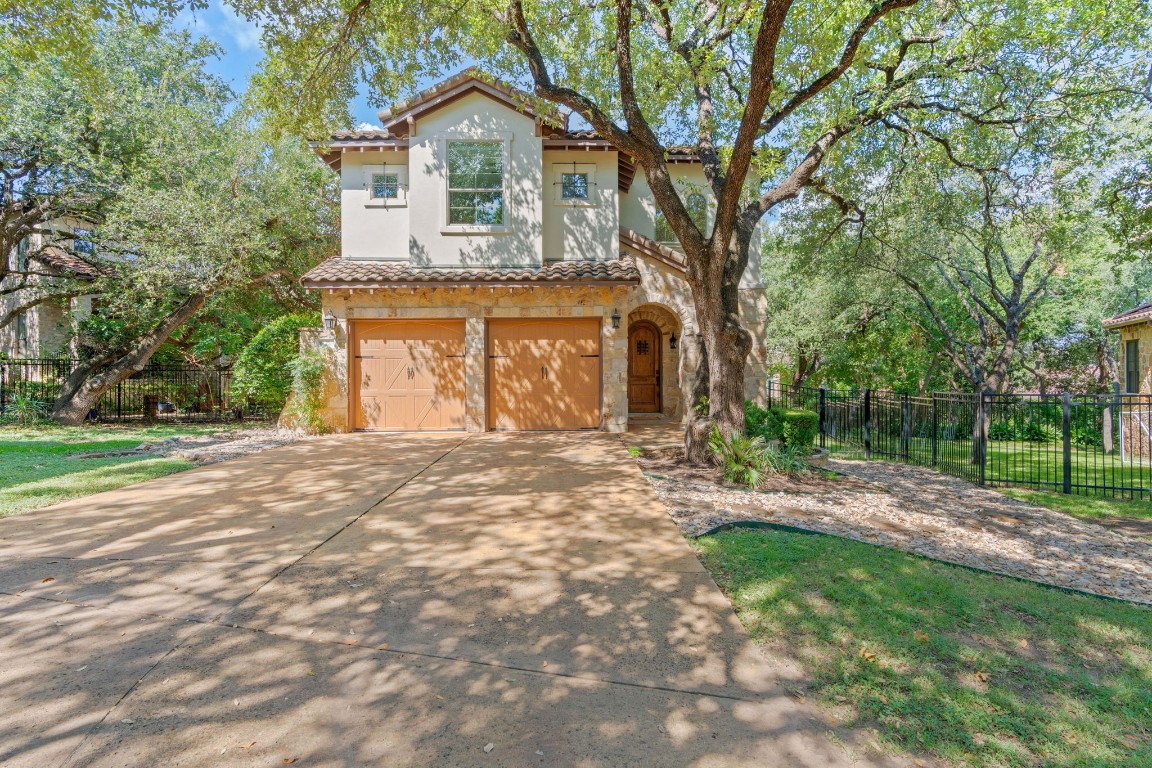 a front view of a house with a garden and yard