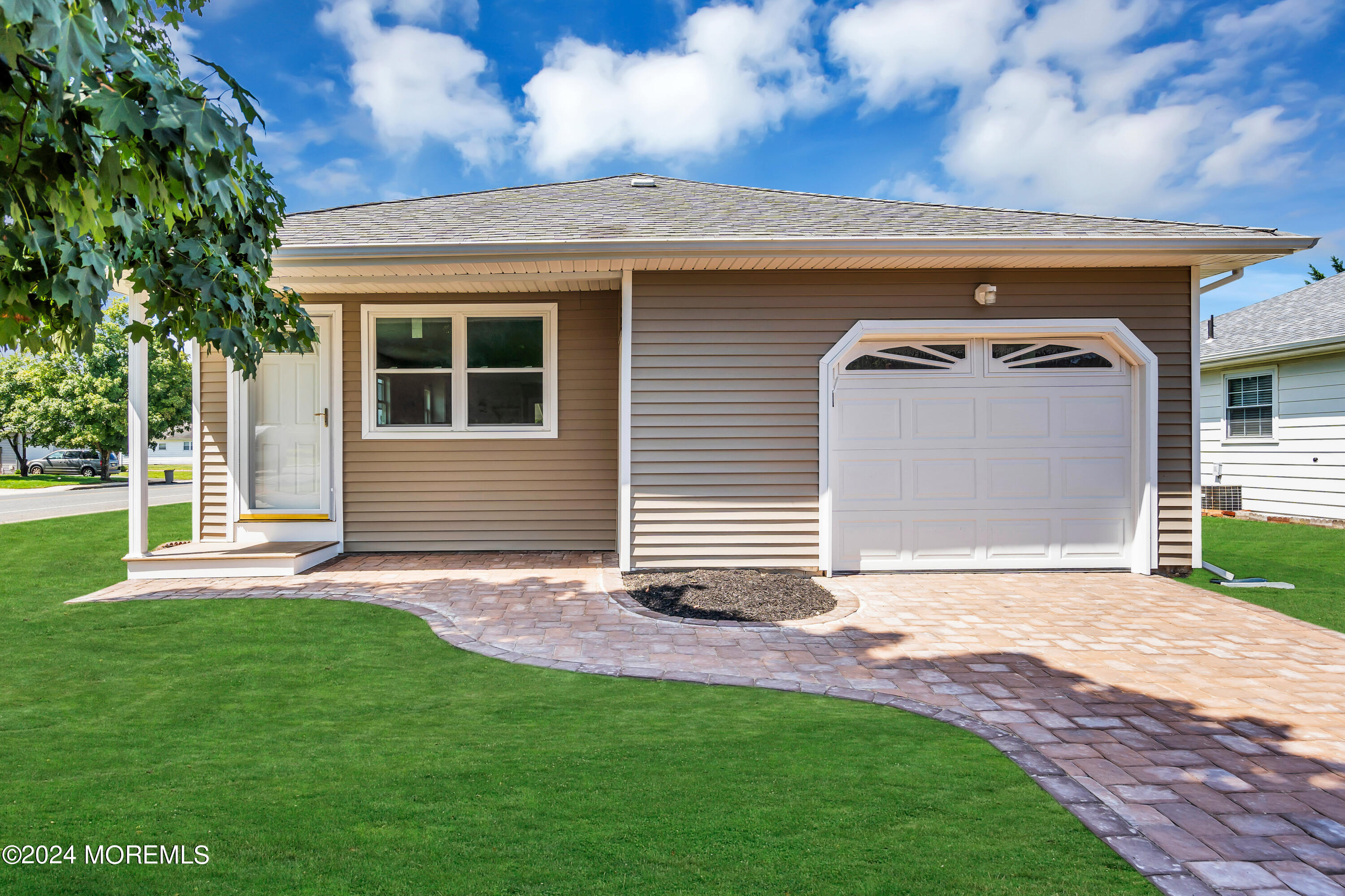 a front view of a house with a garden and yard