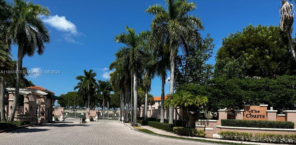 a view of a street with palm trees