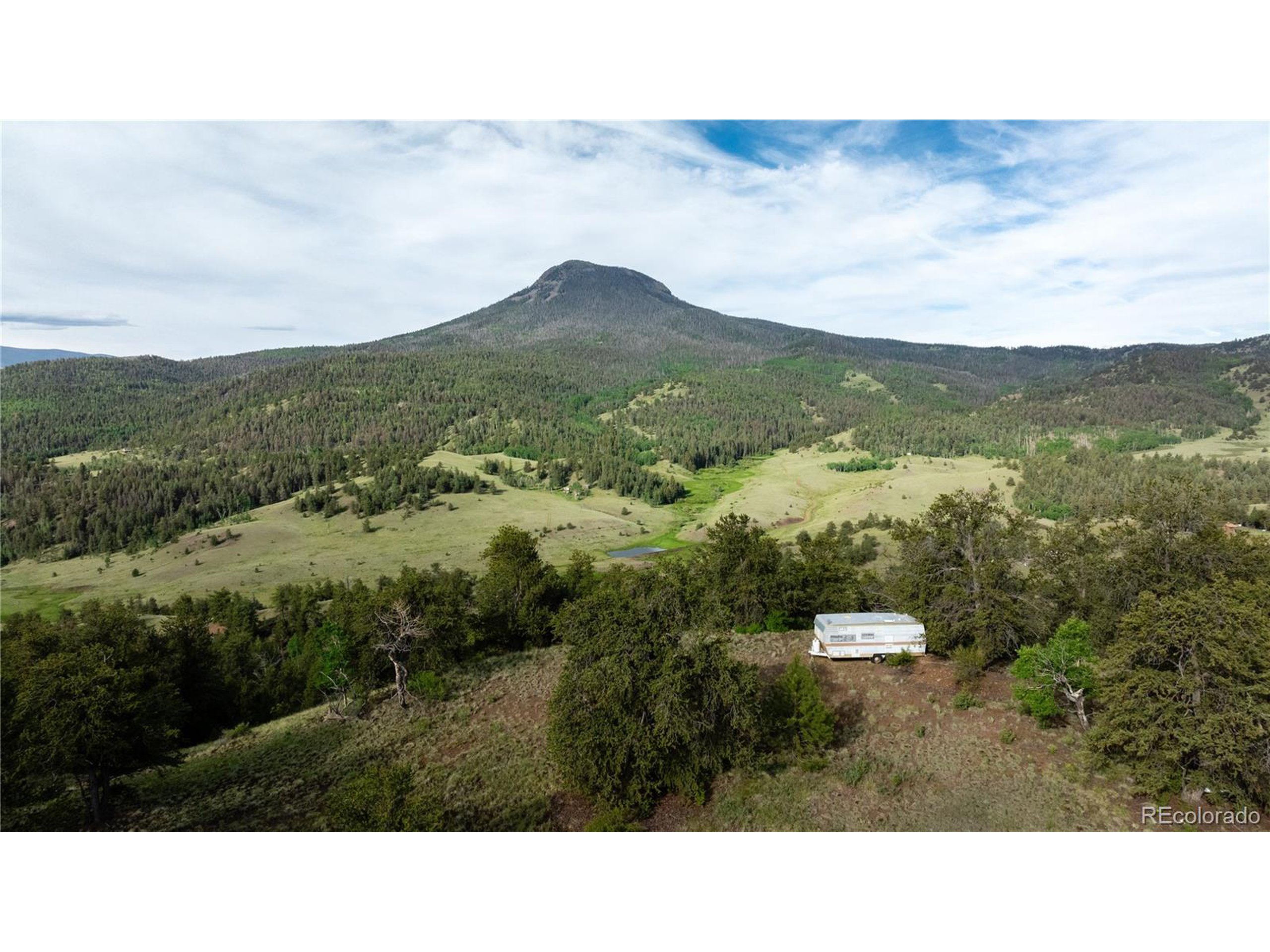 a open area with mountains in the back