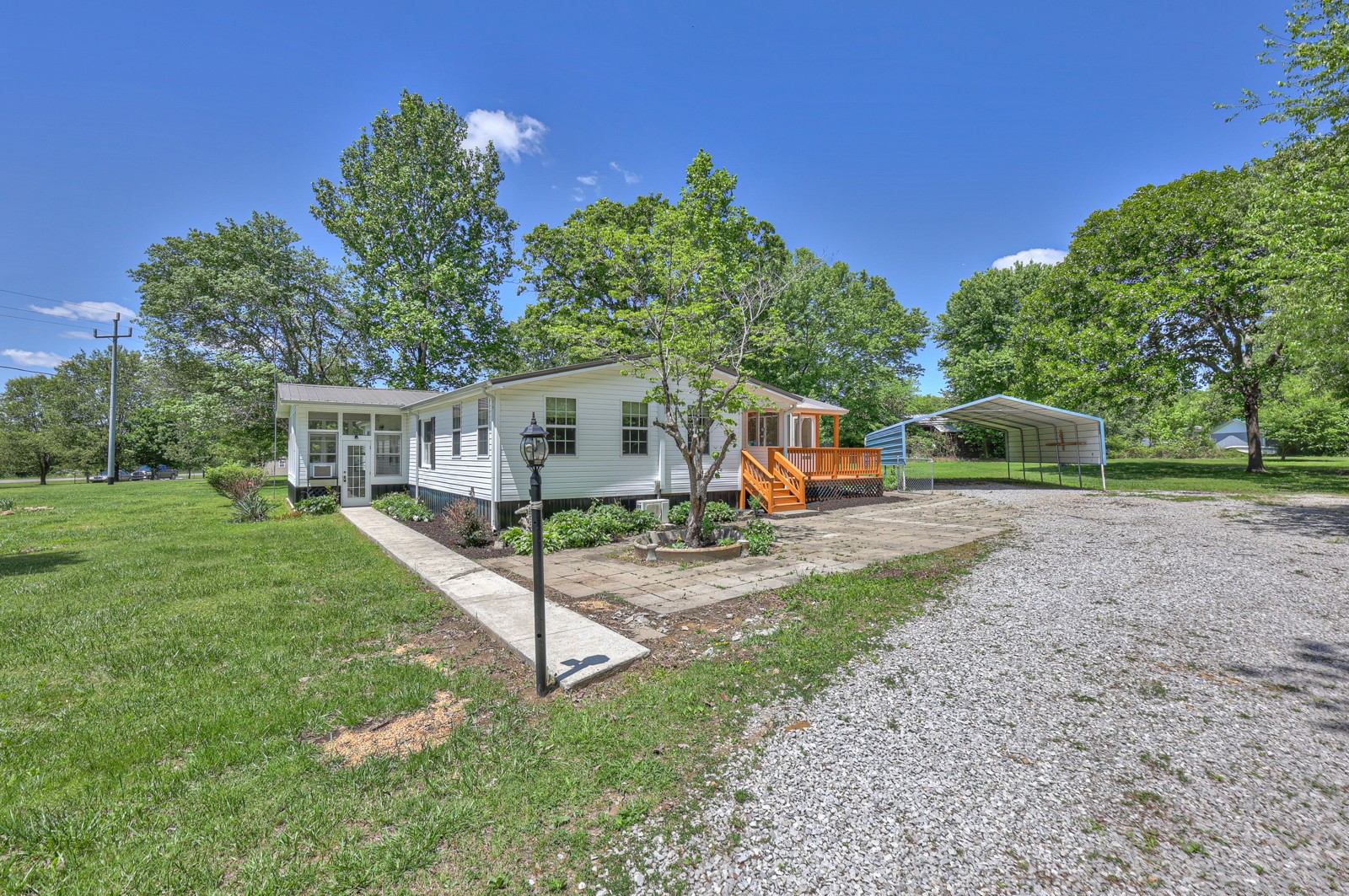 a view of a house with backyard and a tree