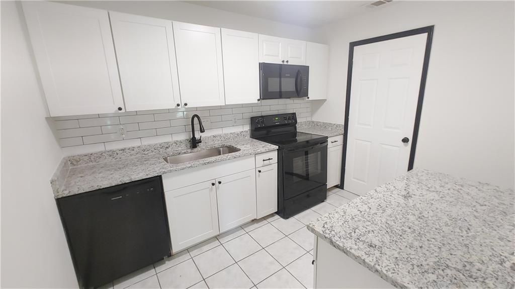 a kitchen with a sink and a stove top oven