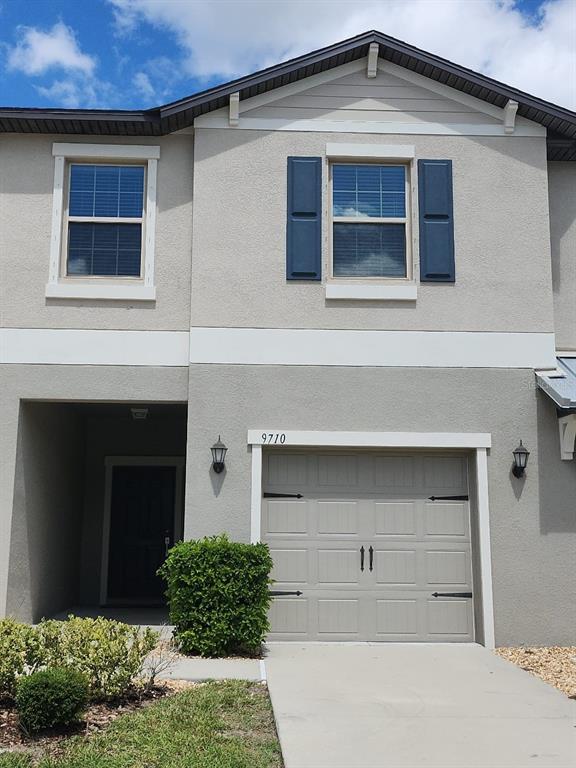 a front view of a house with garage