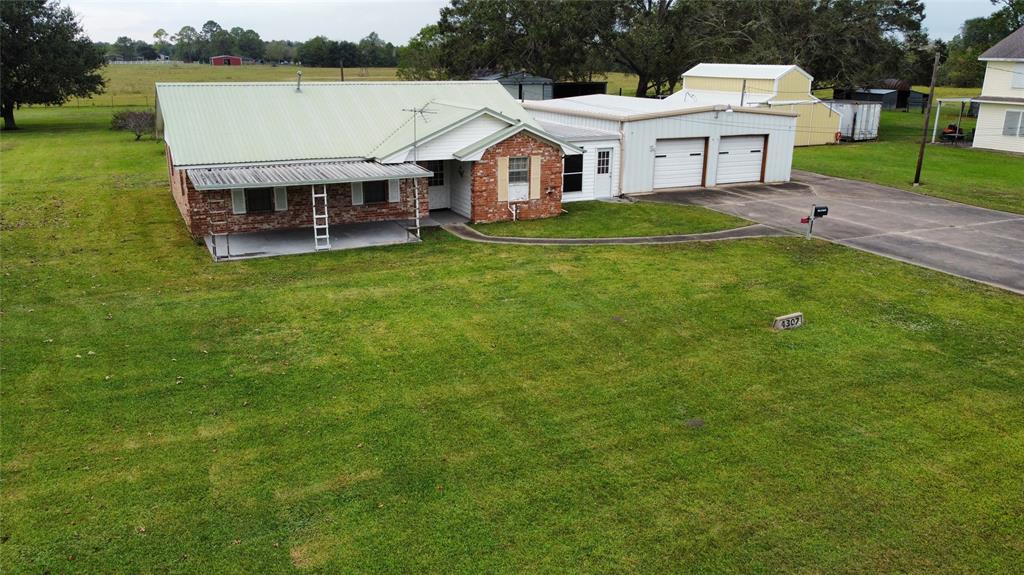 a aerial view of a house with a yard table and chairs