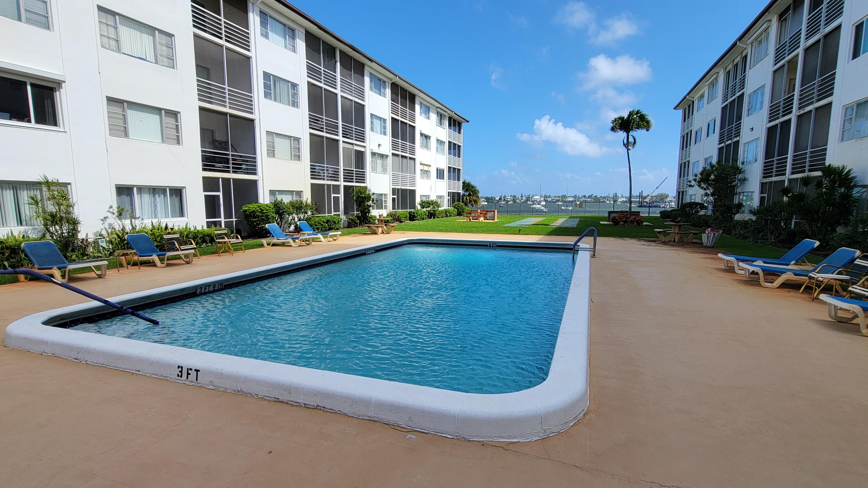 a view of a swimming pool with outdoor seating