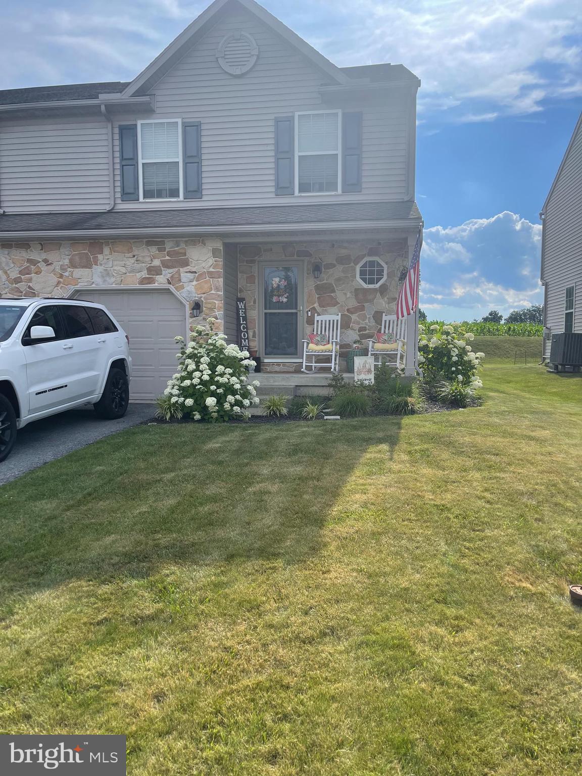 a front view of a house with a garden