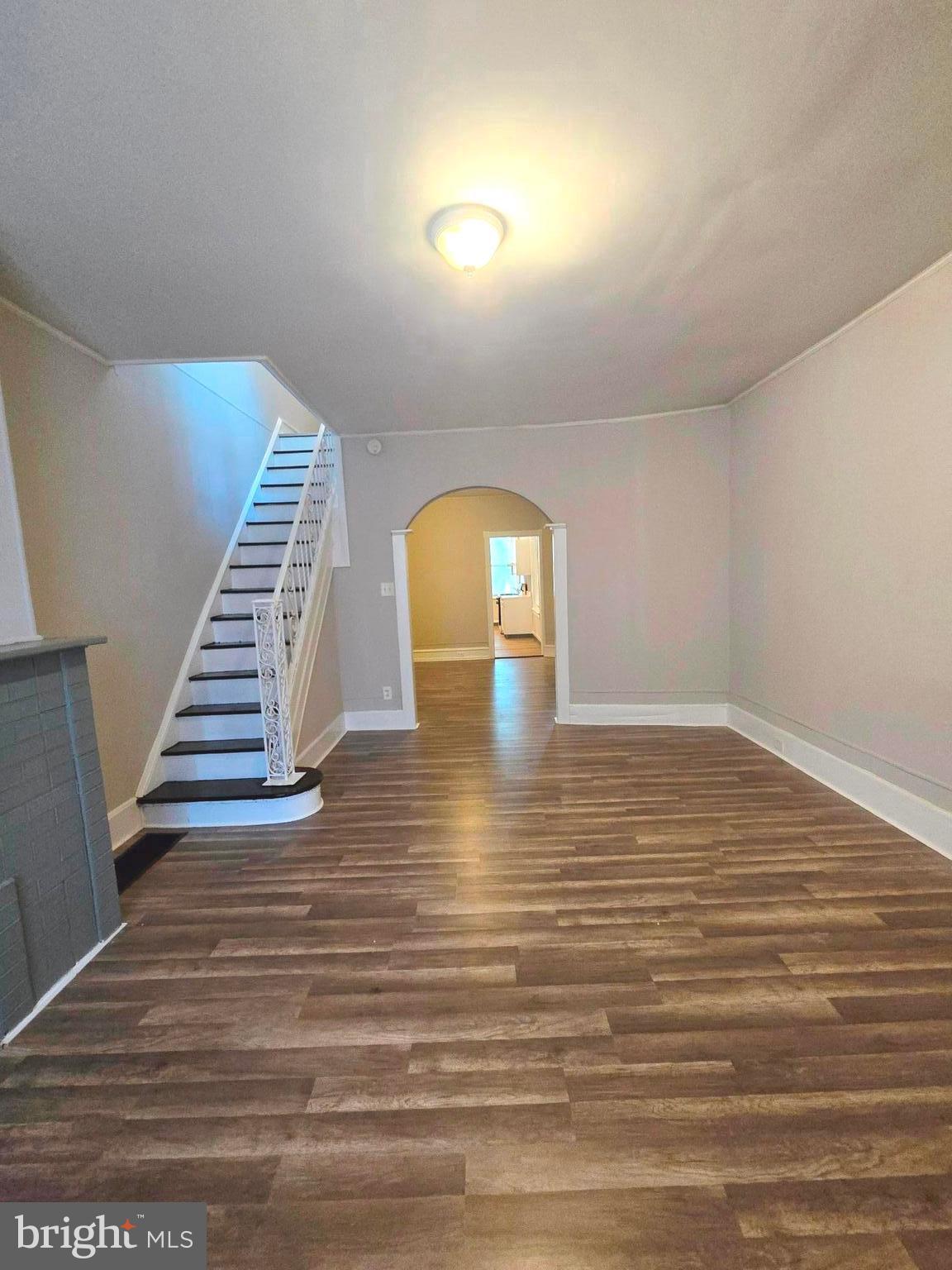 a view of a room with wooden floor and staircase