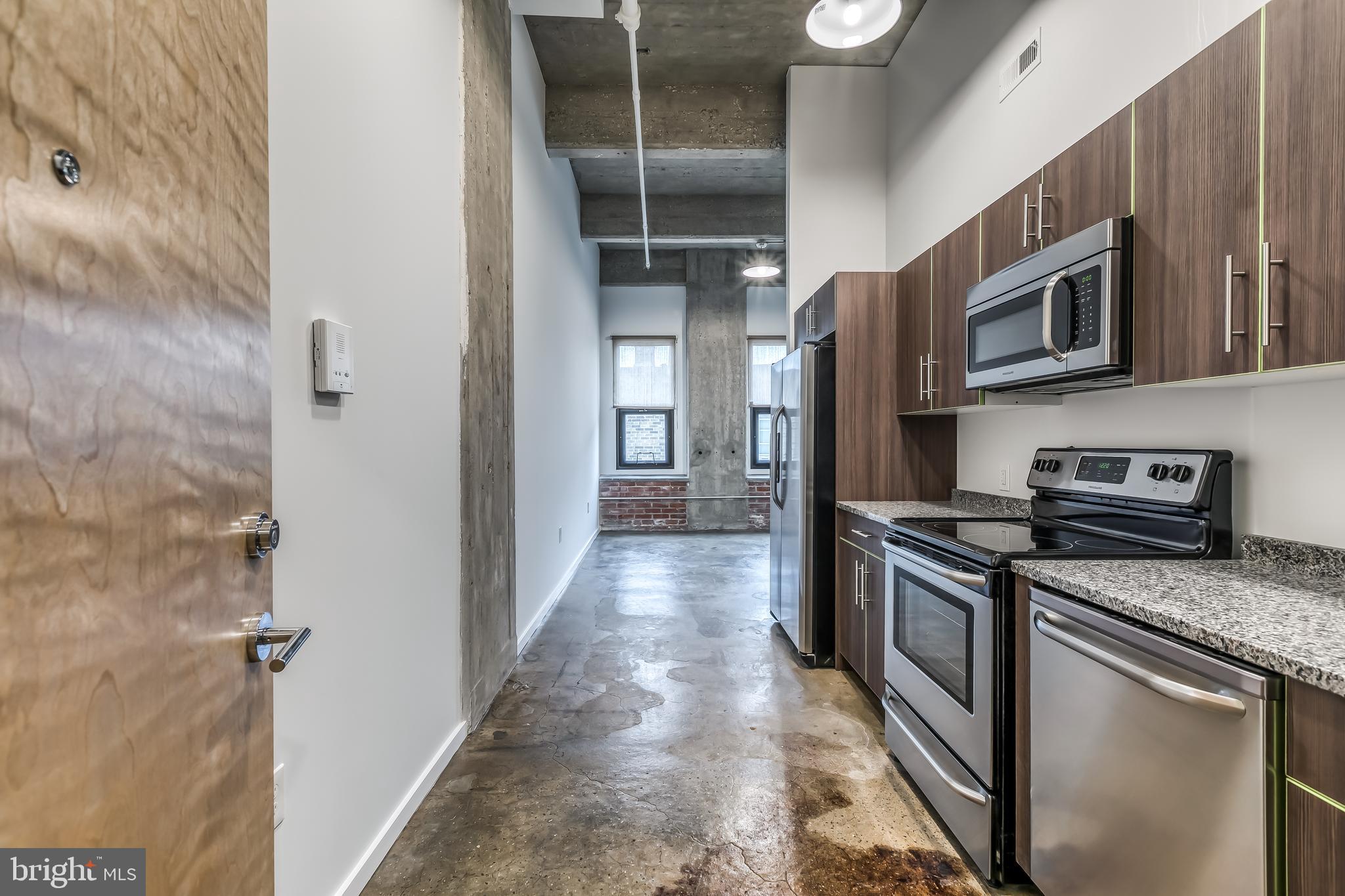 a kitchen with stainless steel appliances granite countertop a stove and a refrigerator