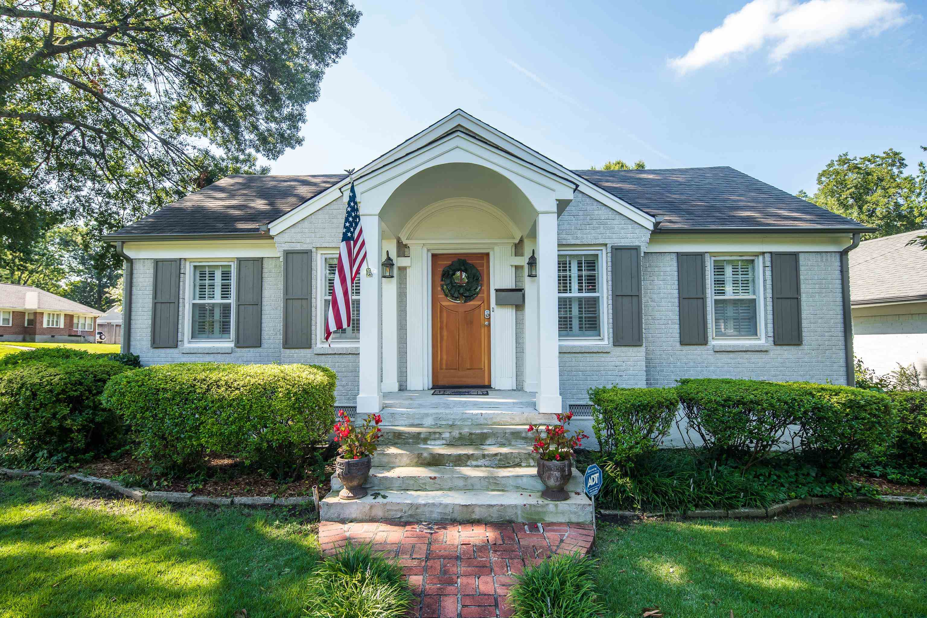 a front view of a house with a garden