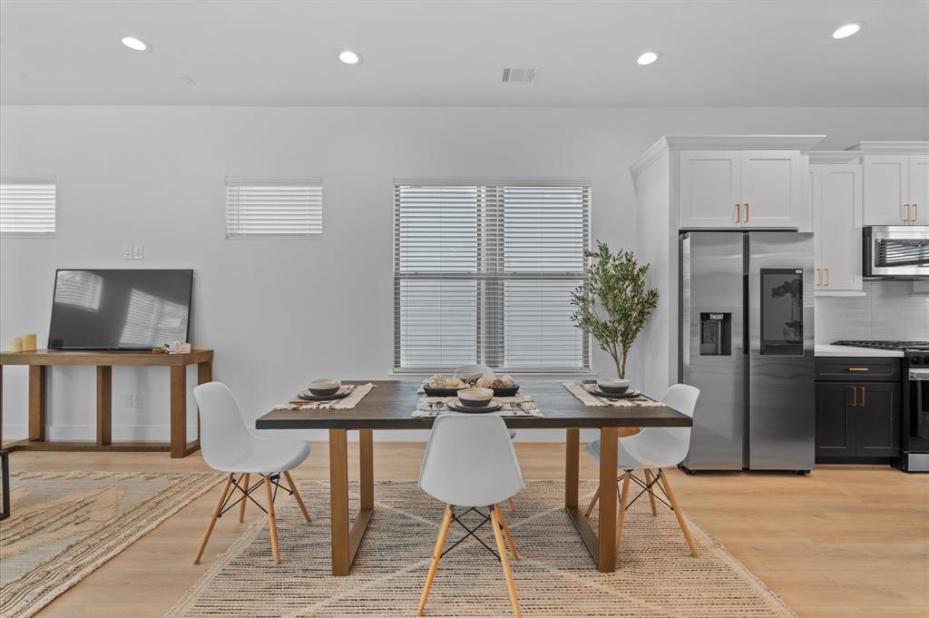 a dining room with furniture and kitchen view