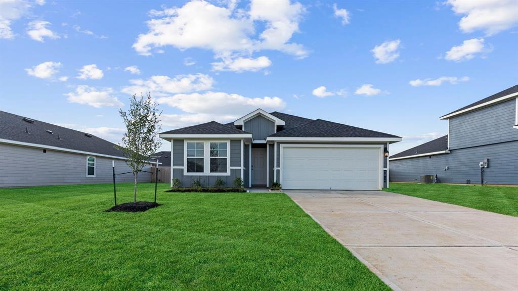 a front view of house with yard and green space