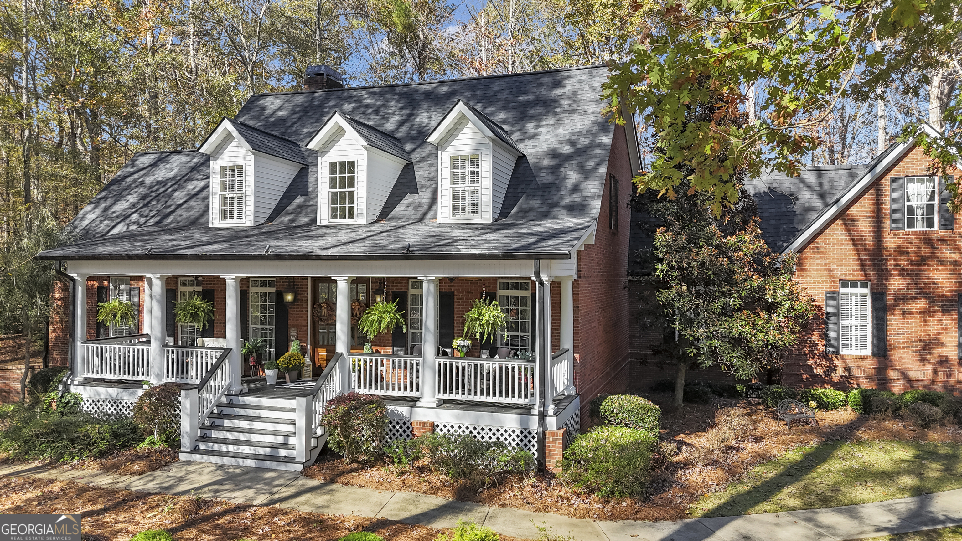 a front view of a house with garden and porch