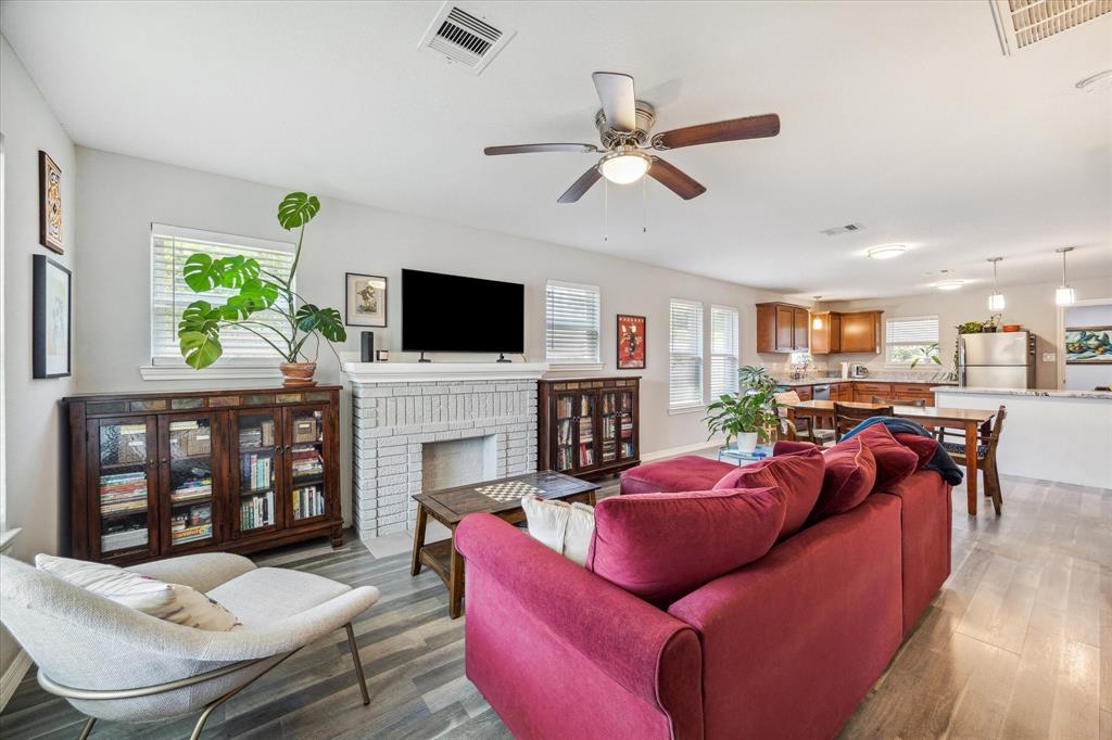 a living room with fireplace furniture and a flat screen tv