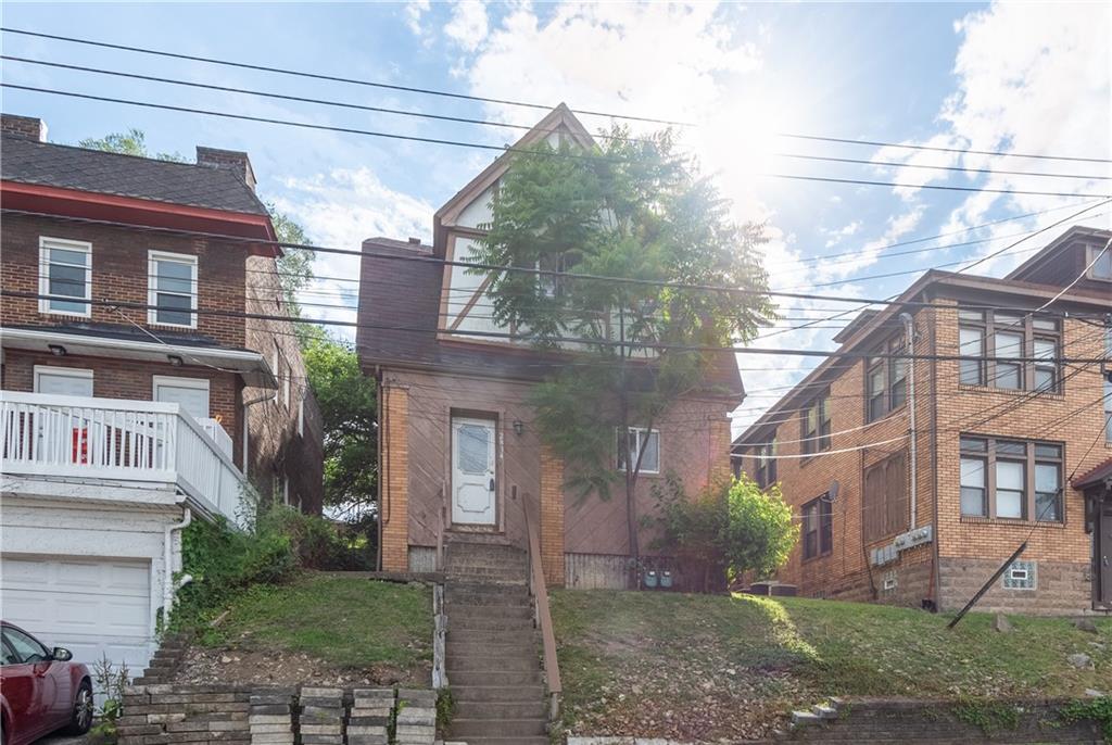 a view of a brick building next to a yard