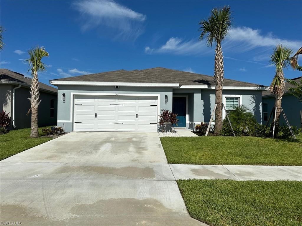 a view of a house with a yard and garage