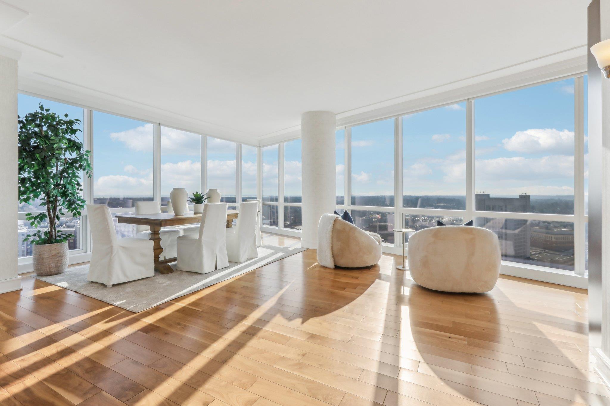 Living room featuring hardwood / wood-style floors, floor to ceiling windows, and a wealth of natural light