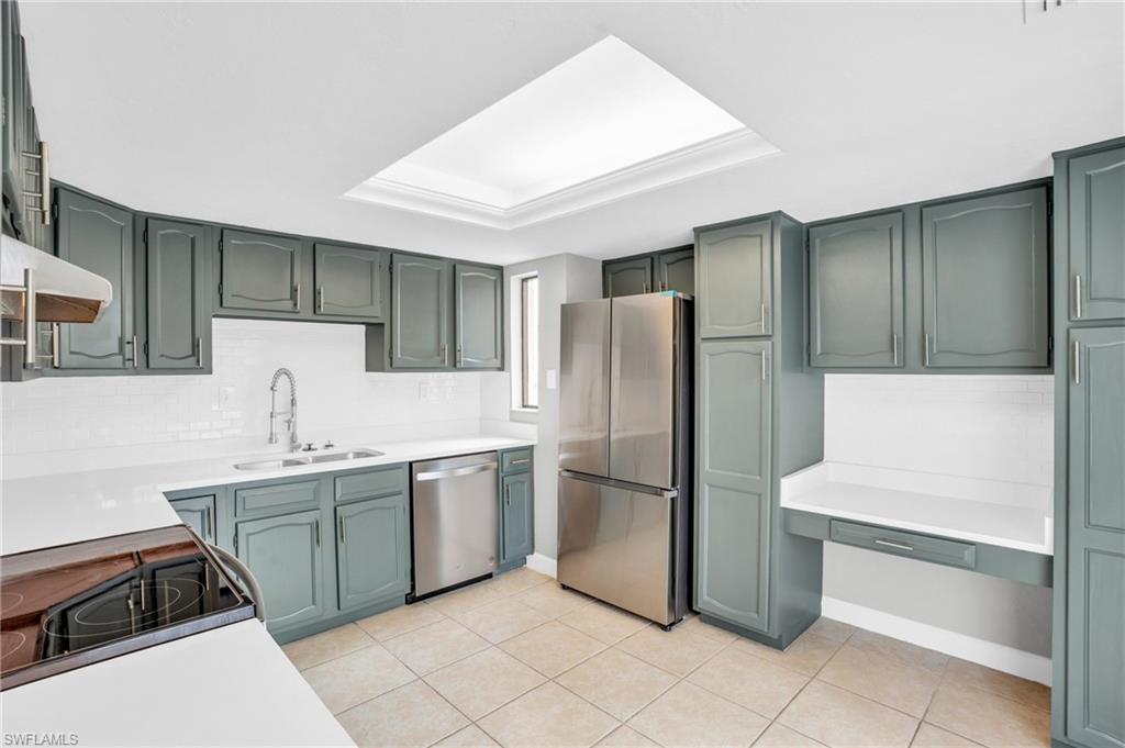 a kitchen with stainless steel appliances a refrigerator and a sink