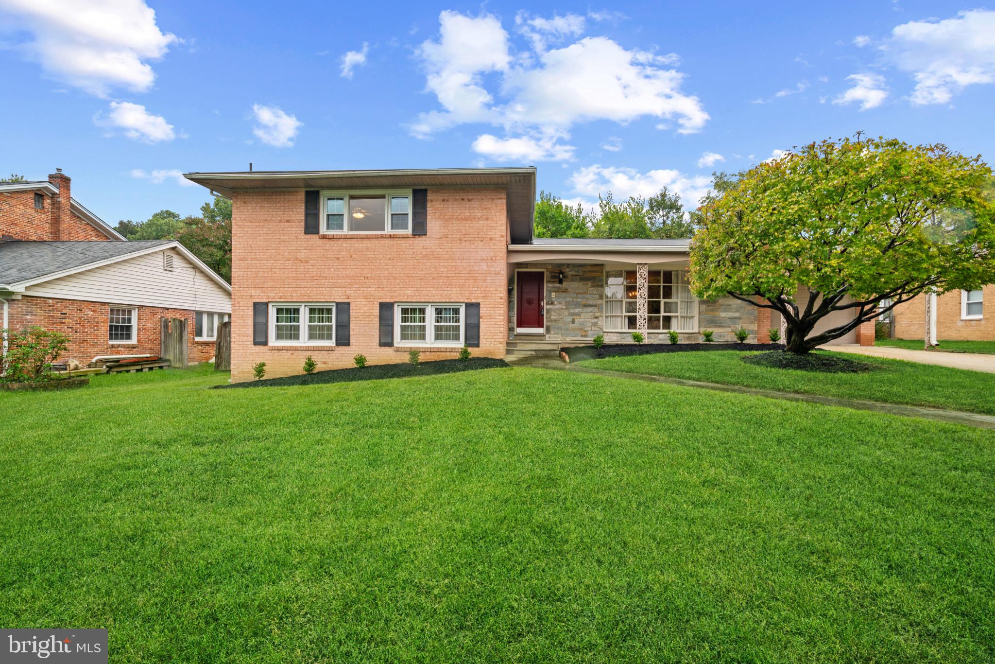 a front view of house with yard and green space