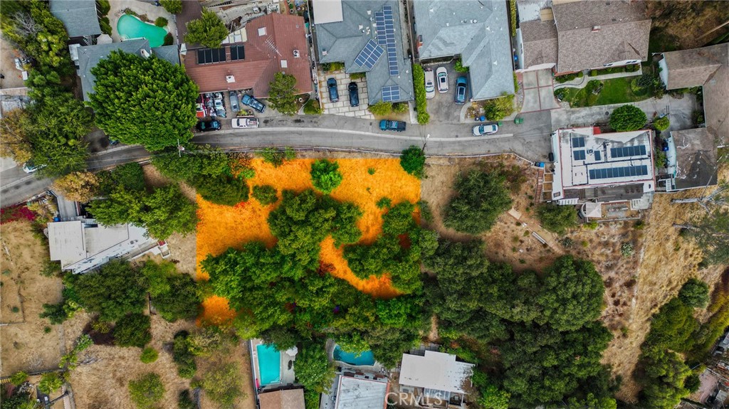 an aerial view of residential houses with outdoor space and swimming pool