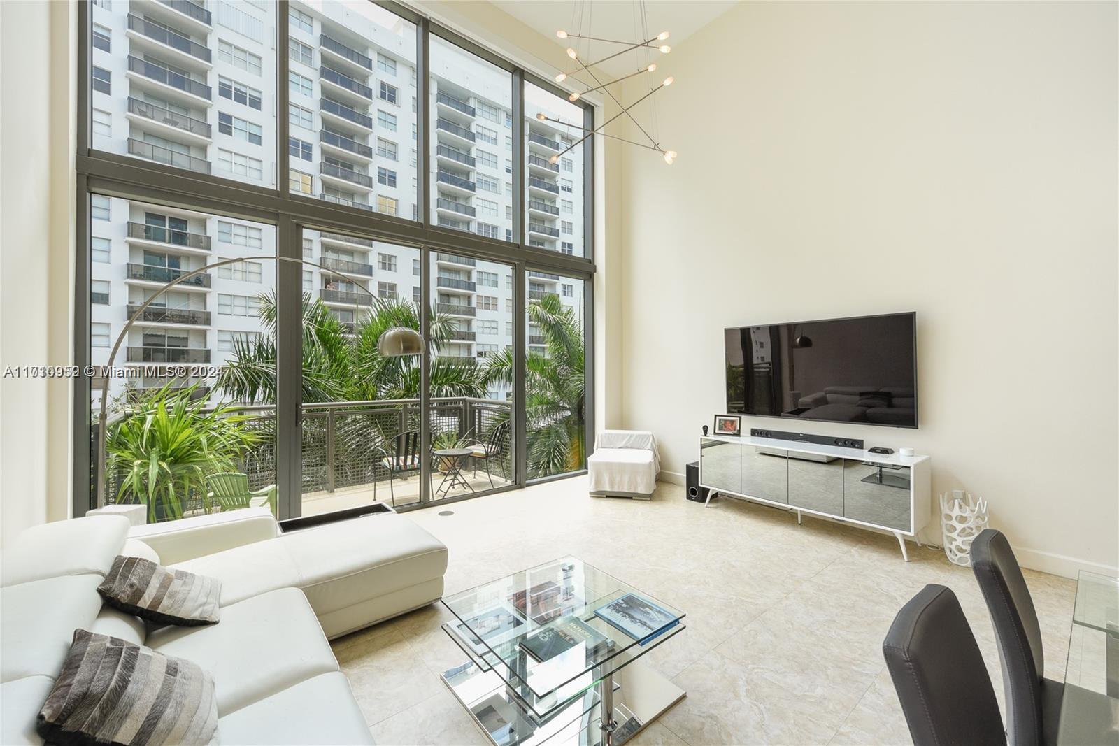 a living room with furniture tv and a large window