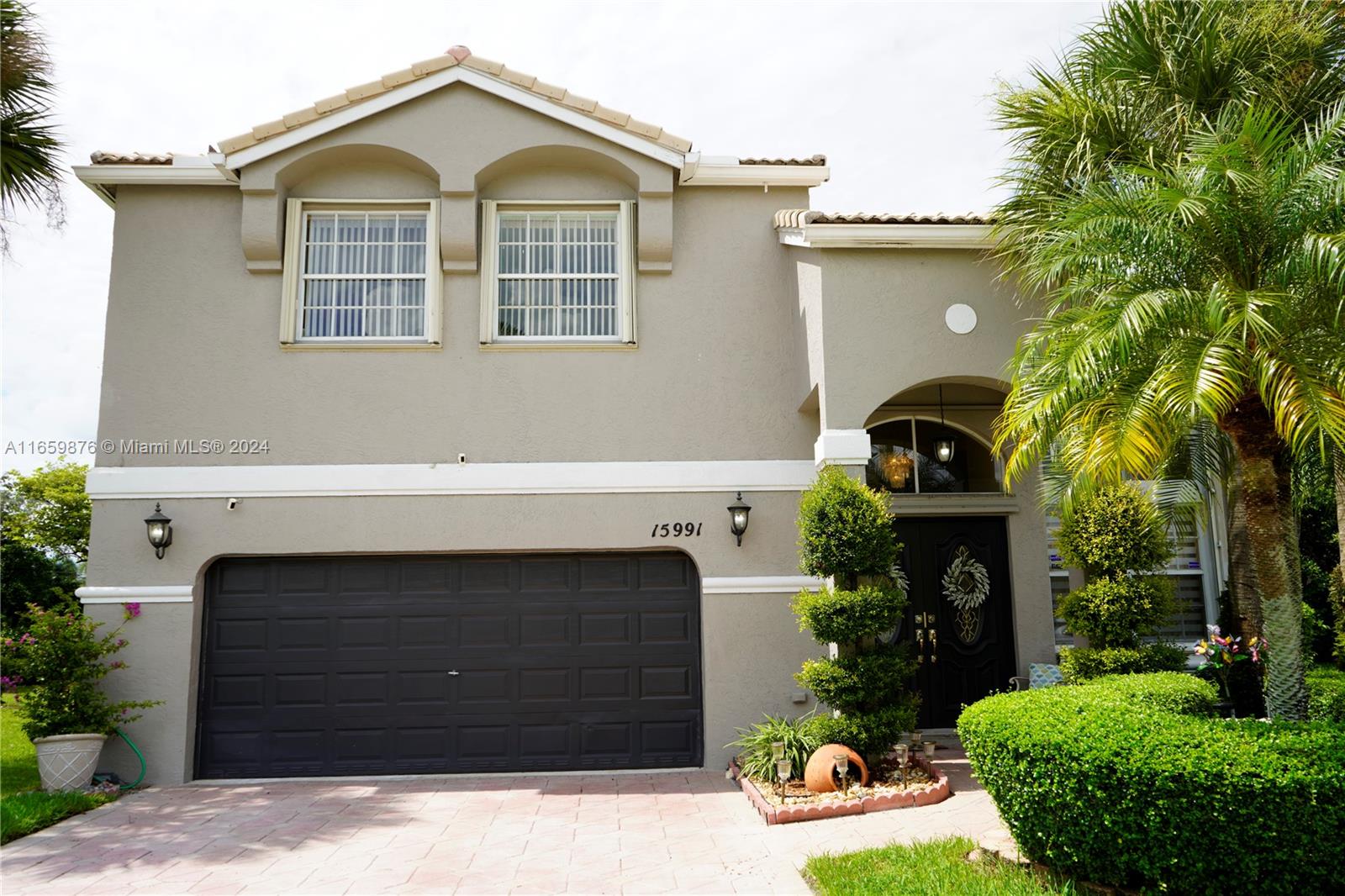 a front view of a house with a yard and garage