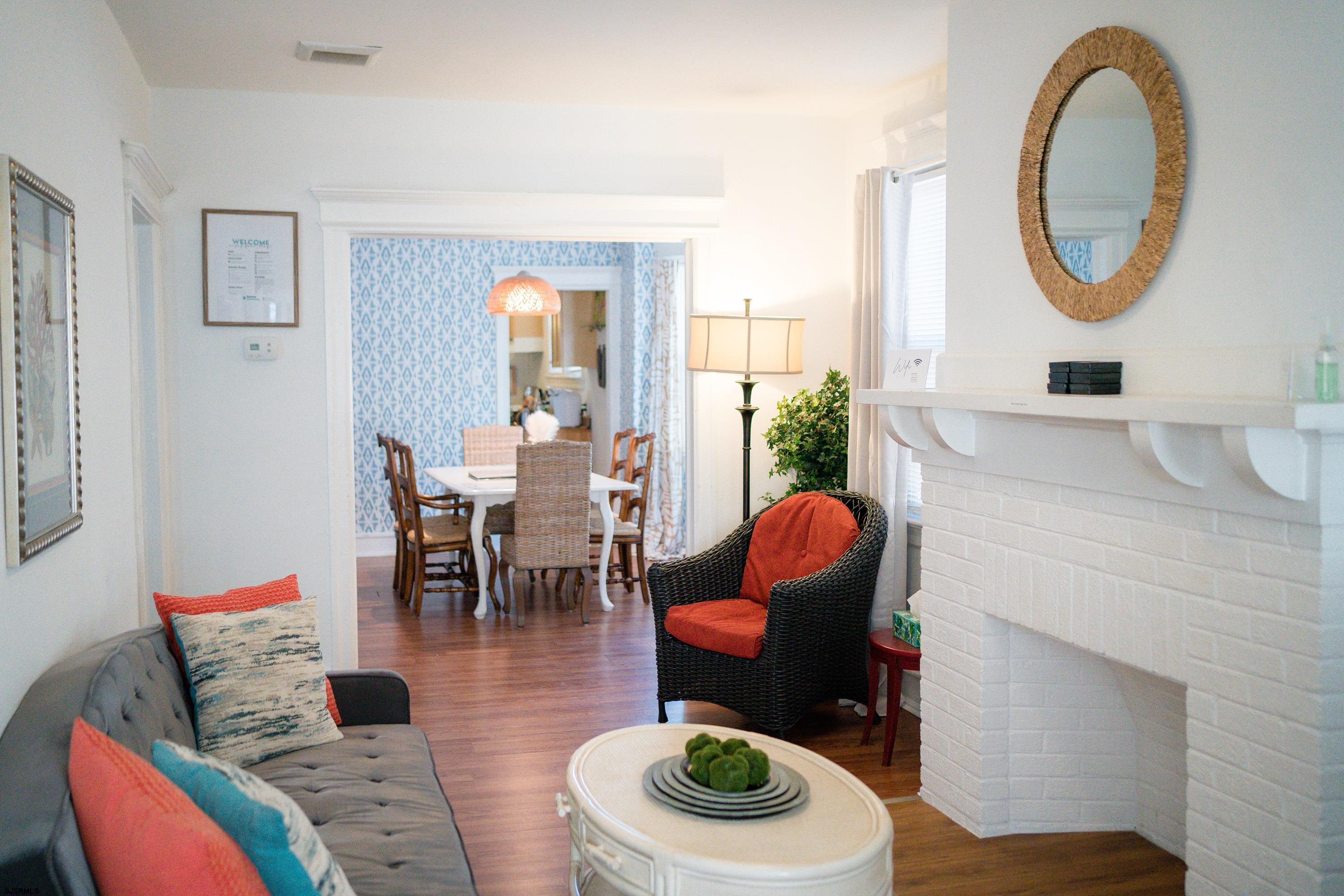 a living room with furniture a mirror and a table