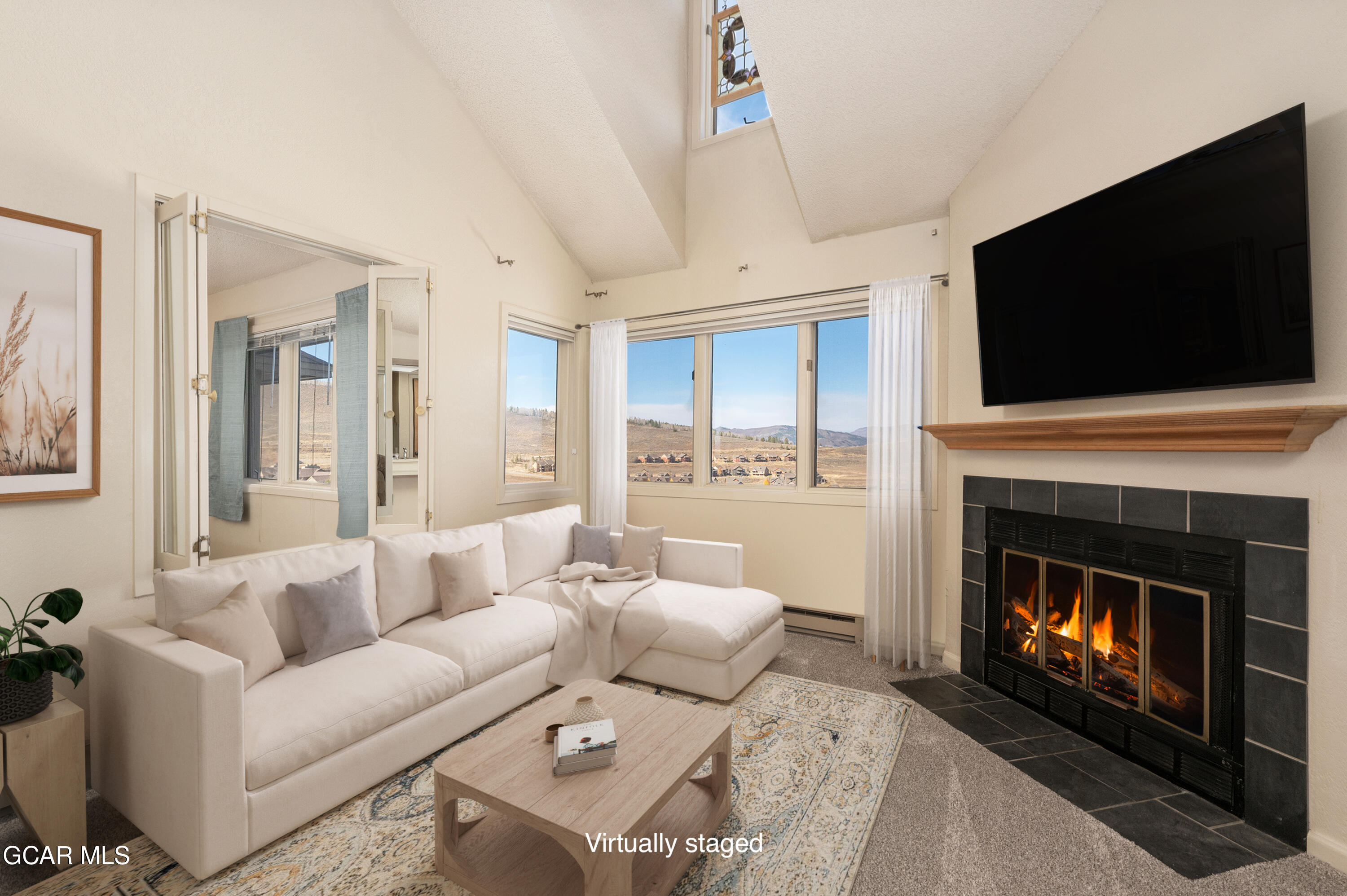 a living room with furniture a fireplace and a flat screen tv