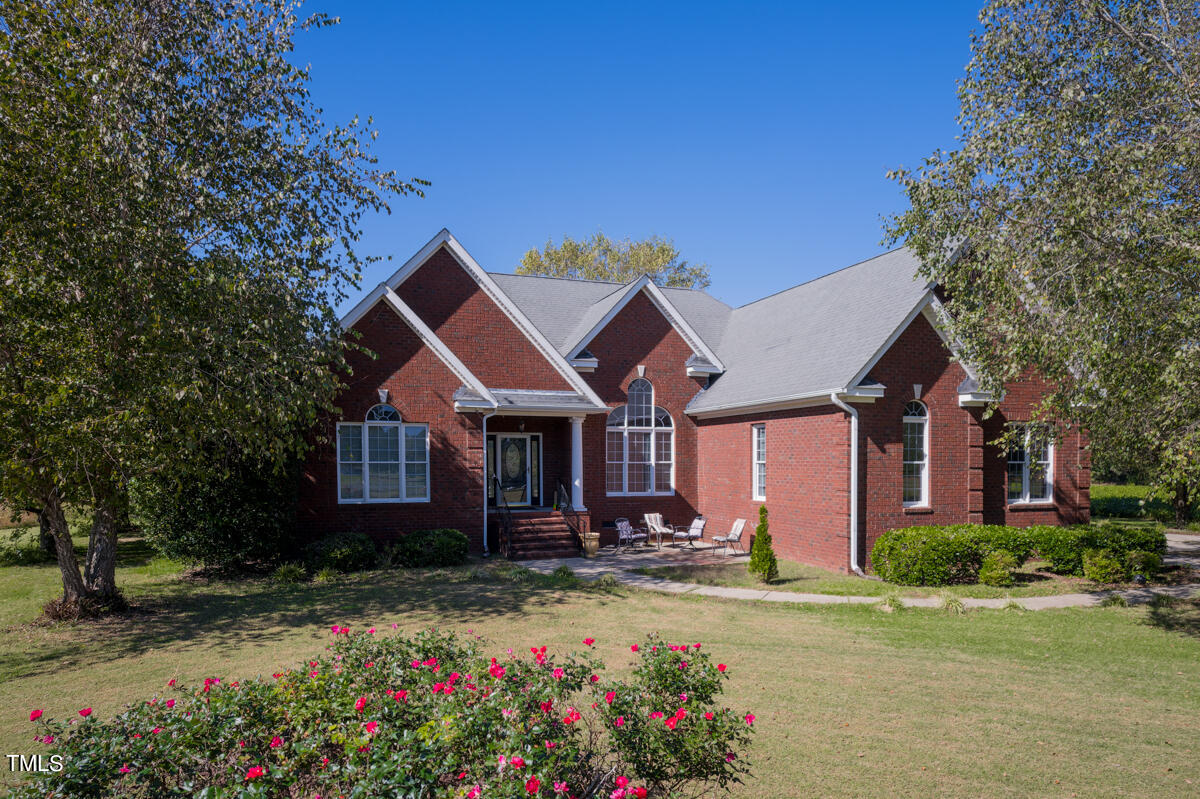 a front view of a house with garden