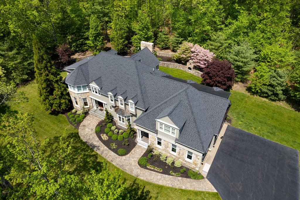 an aerial view of a house with outdoor space pool seating area and yard