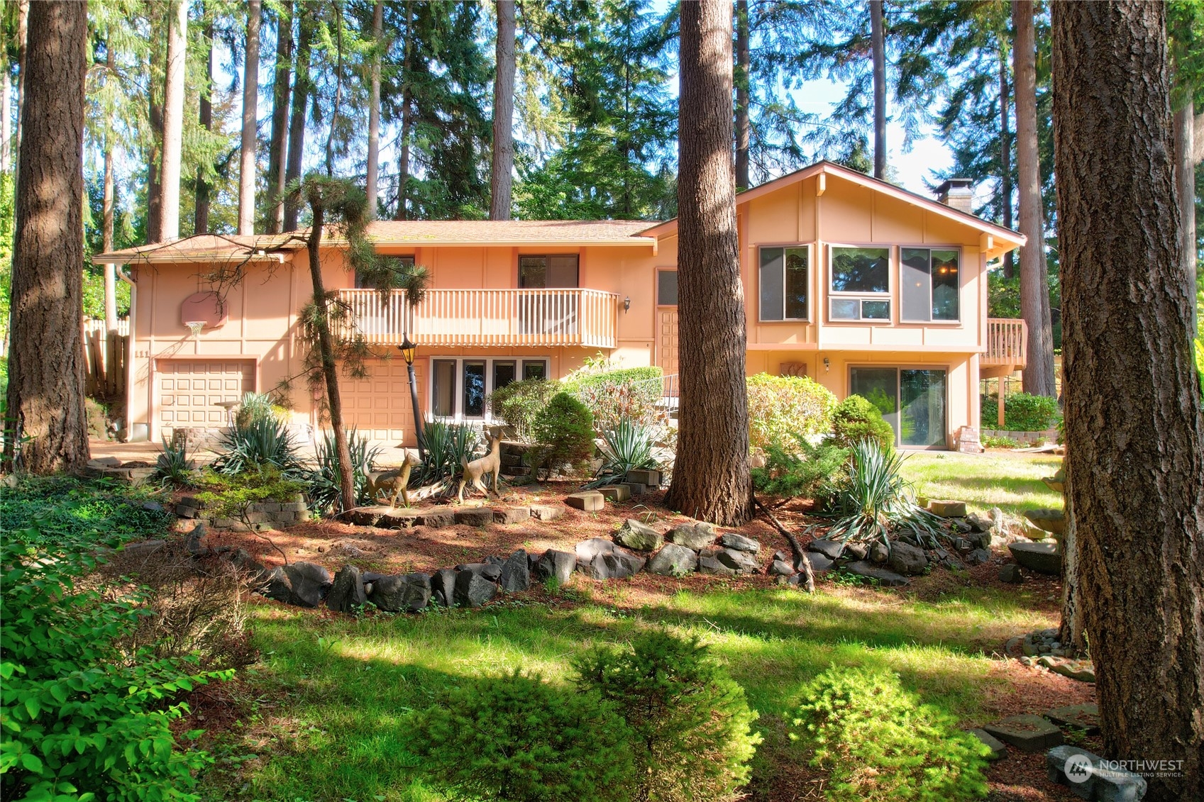 a view of a house with backyard and sitting area