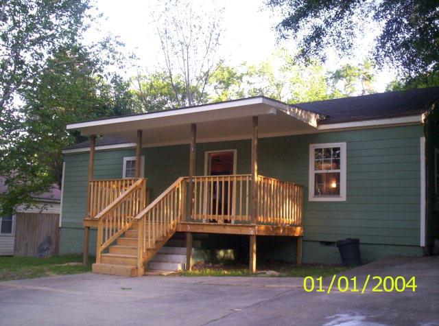 a view of house with a yard and balcony