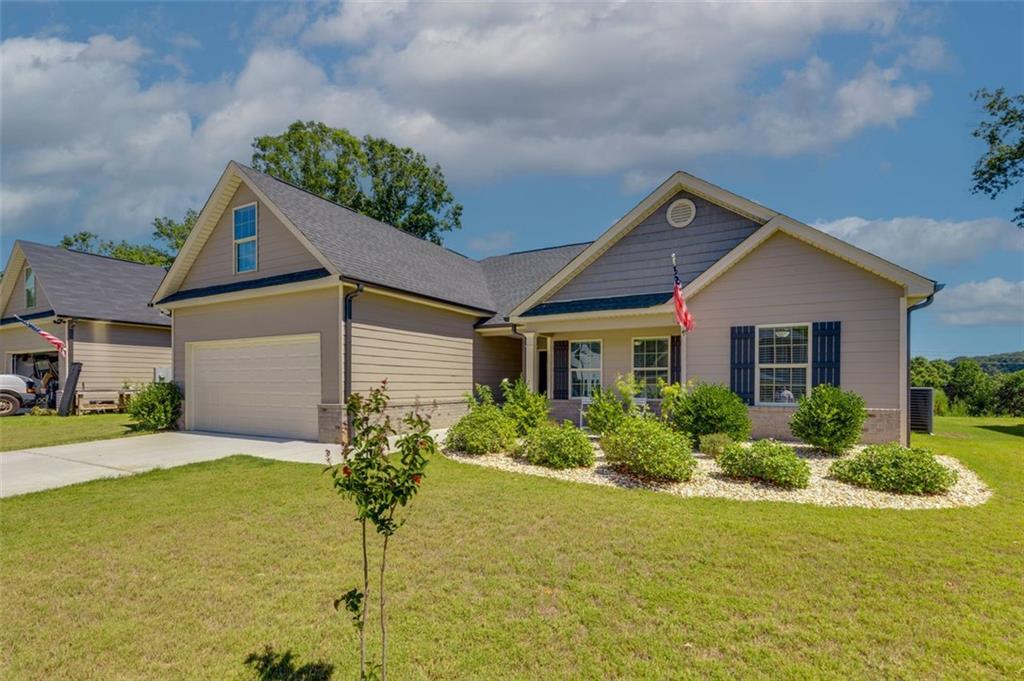 a front view of house with yard and green space