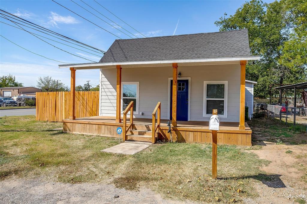 a view of a house with backyard porch and sitting area