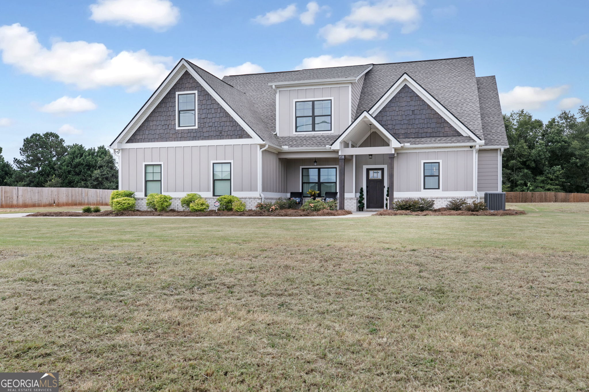 a front view of house with yard and green space