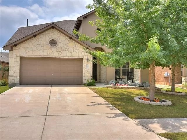 a front view of a house with a yard