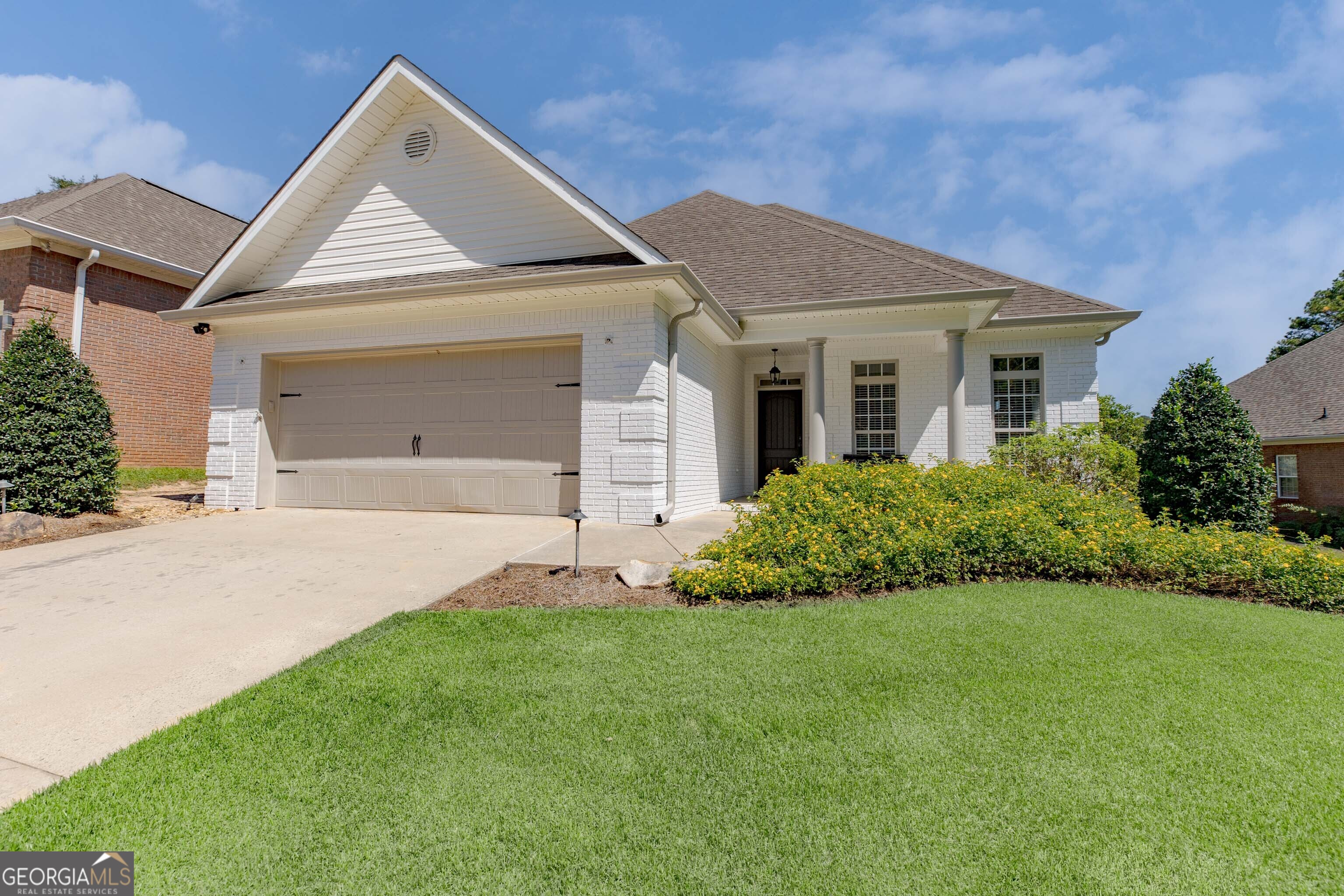 a front view of a house with a yard and garage