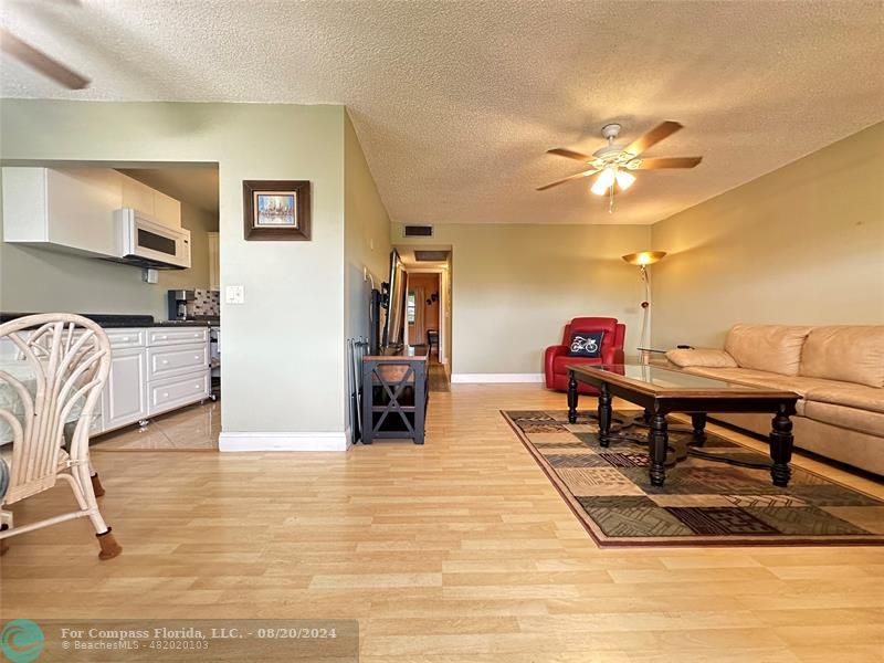 a view of a livingroom with furniture and a kitchen