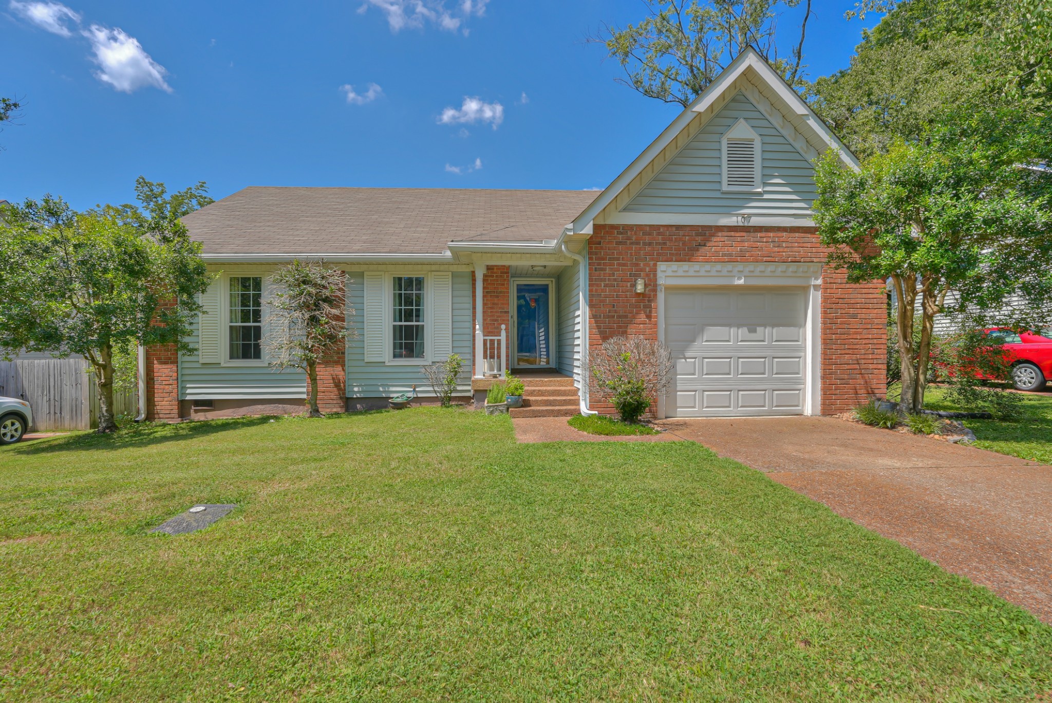 a view of a house with backyard and porch