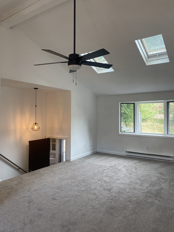 a view of a livingroom with a ceiling fan and window