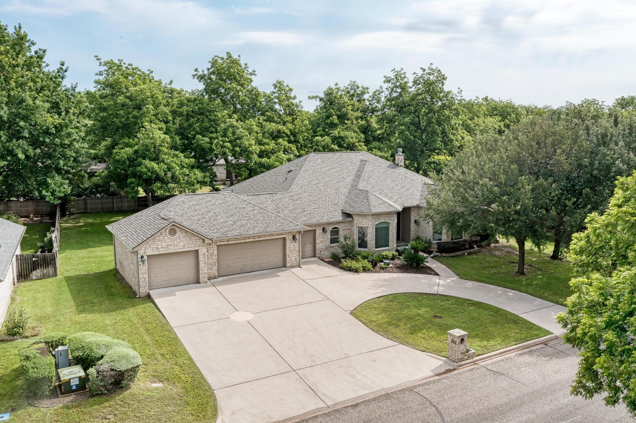 an aerial view of a house with swimming pool and garden